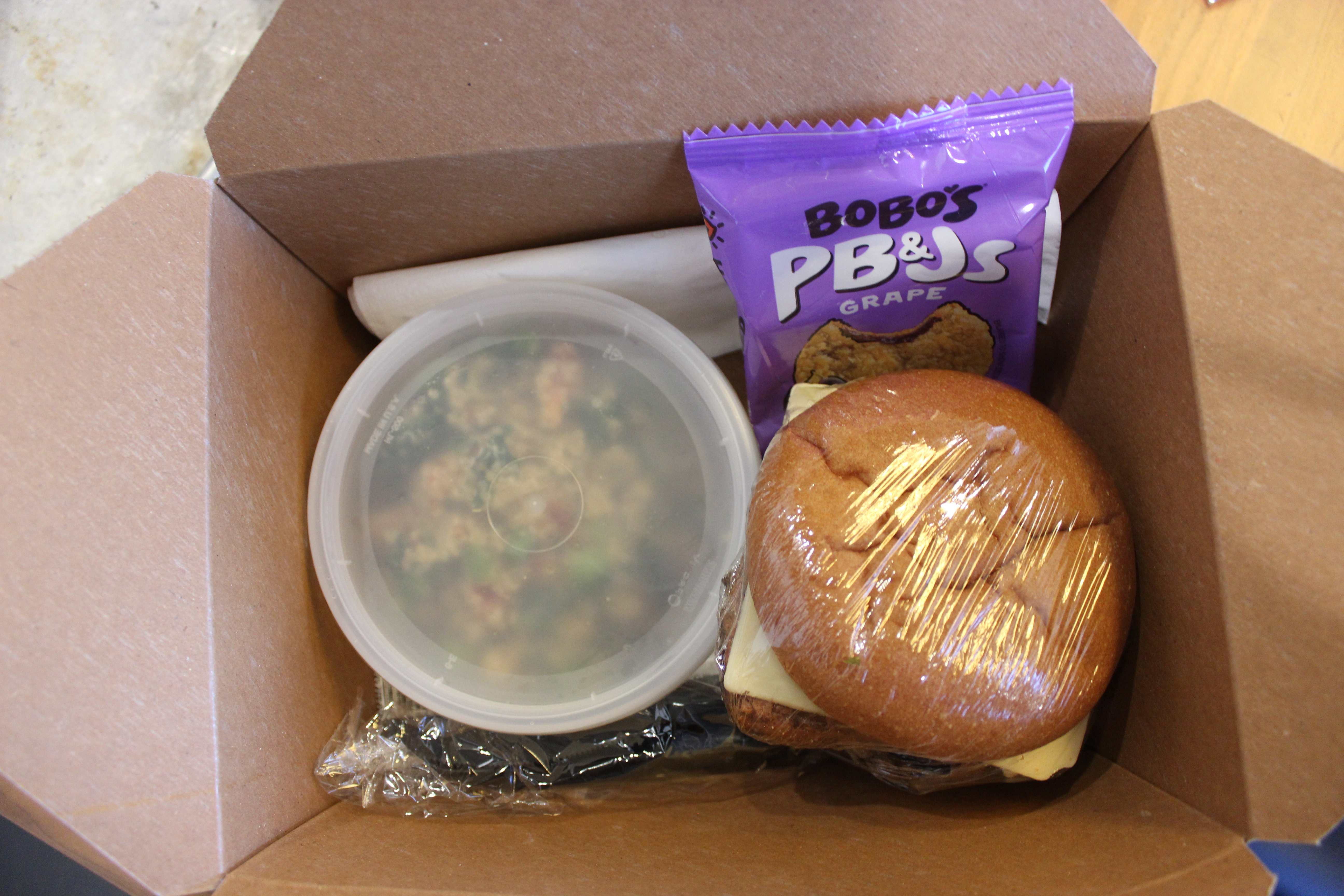 Plant-Based Chicken on Gluten-Free Bun with Quinoa Salad and Bobo's Peanut Butter Oat Crust Bar.